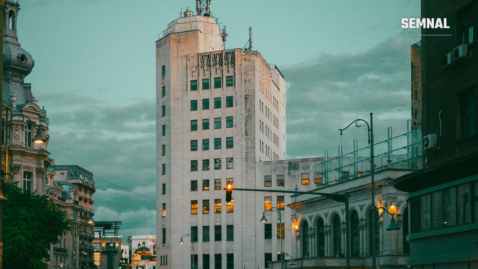Turnul Palatului Telefoanelor din centrul Bucureștiului, fotografiat în amurg, printre alte clădiri de birouri din capitală