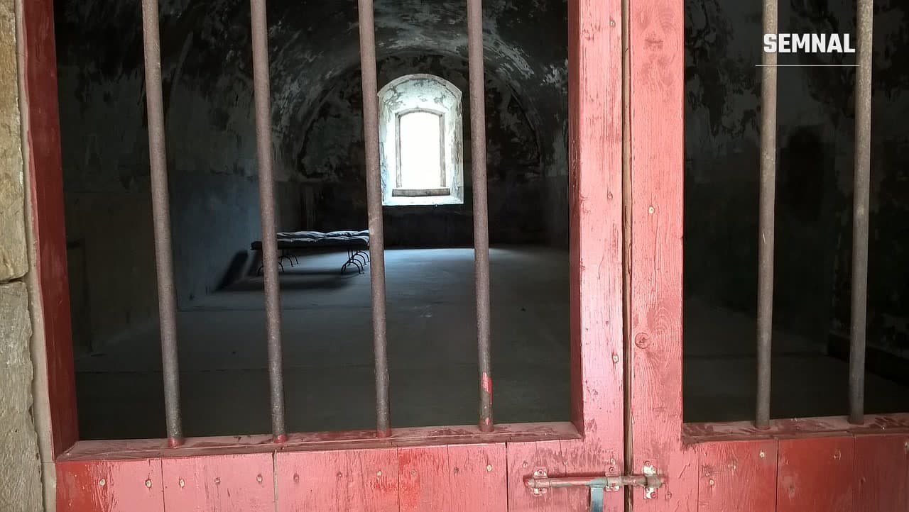 Celulă de închisoare văzută prin gratii, imagine ilustrativă