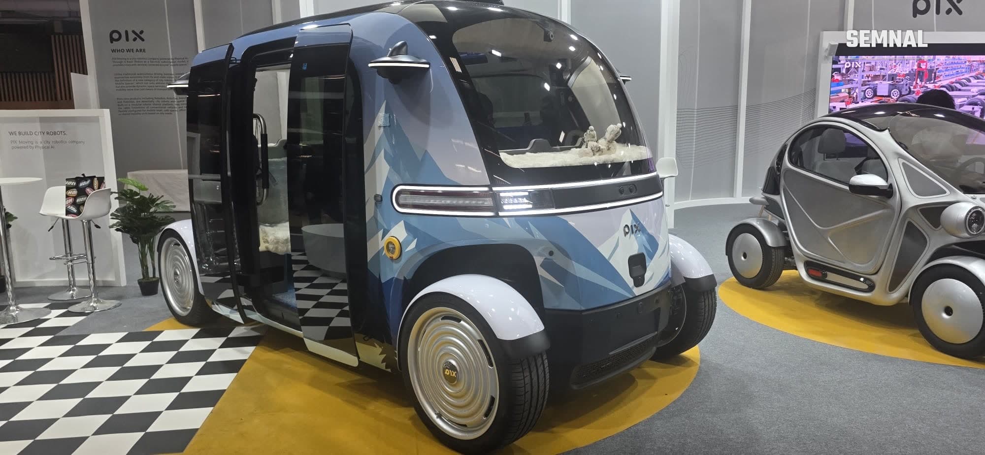 Microbuz autonom PIX Moving, cu ușile deschise, pe standul de la Salonul Auto de la Paris 2026