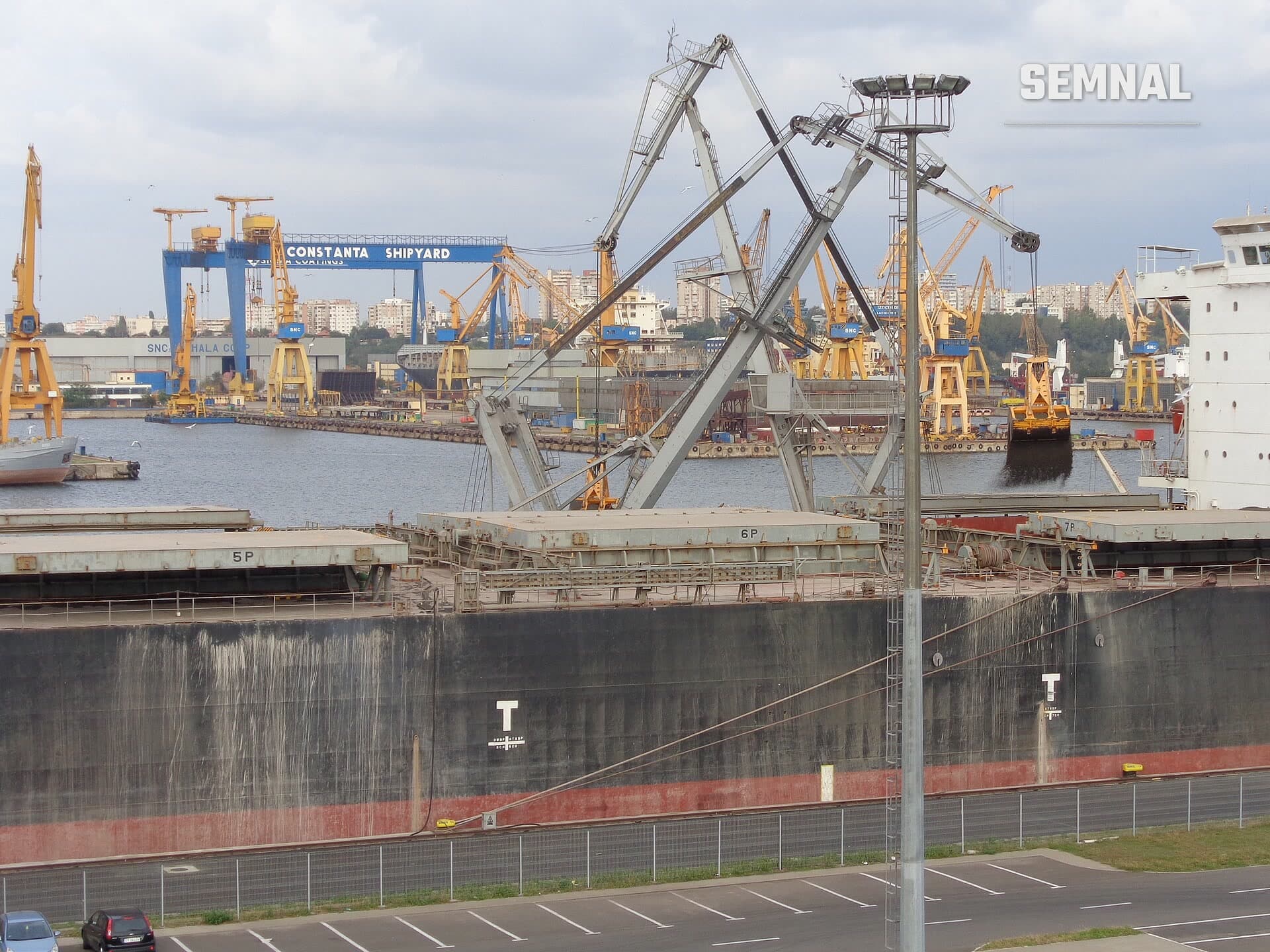 Imagine ilustrativă: un transportator de vrac ancorat în portul Constanța, cu macarale galbene și șantierul naval în fundal. Nu este nava Khoryv.