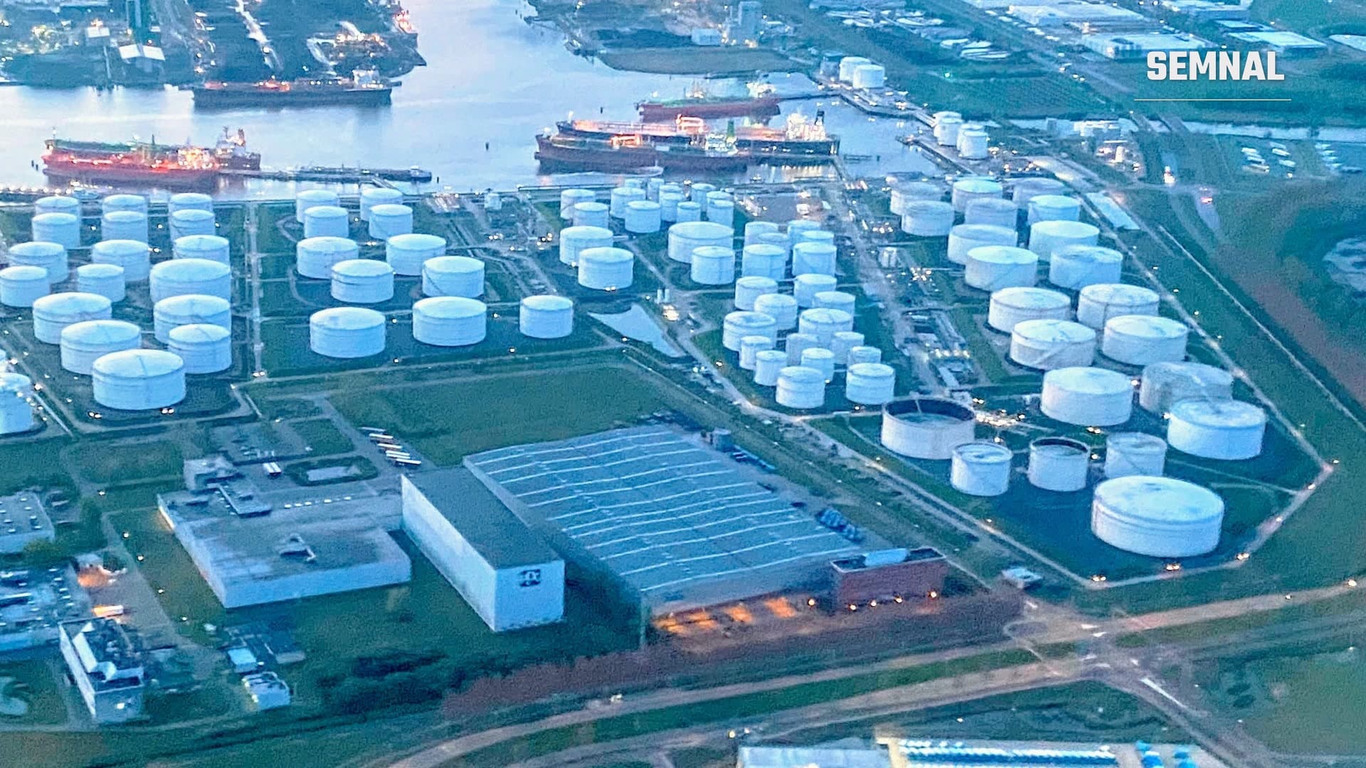 Vedere aeriană a unui terminal petrolier cu zeci de rezervoare albe și petroliere acostate la cheu. Imagine ilustrativă, nu de la Oil Terminal Constanța.