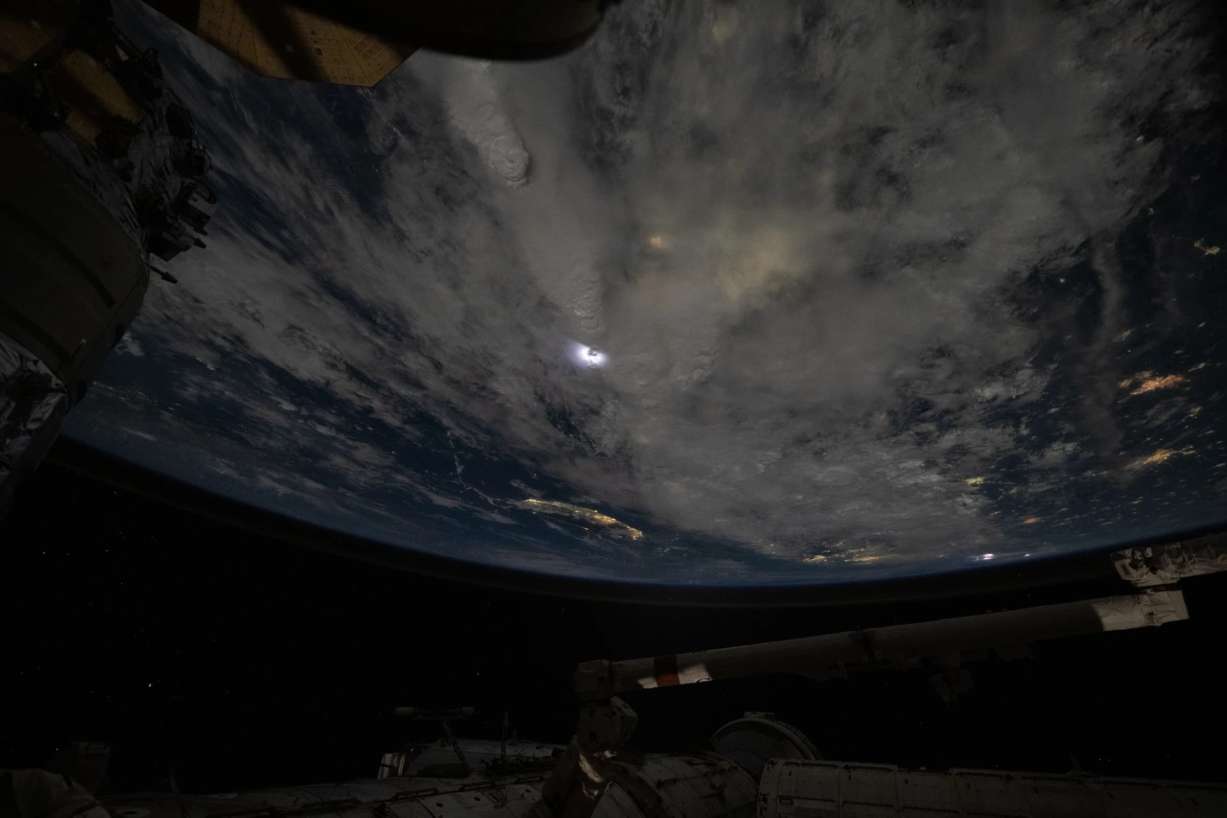 Iss071e620932 (Aug. 20, 2024) --- Lightning (at center) illuminates the storm clouds above China
