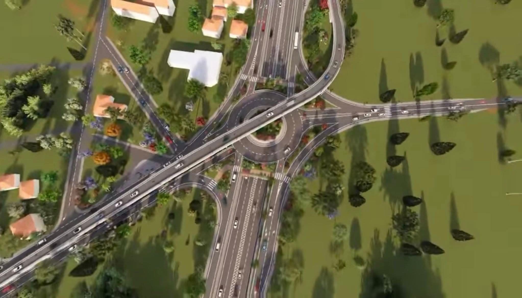 Perspectivă aeriană a unui nod rutier multilevel cu autostrăzi, sensuri giratorii și vehicule în trafic, înconjurat de arbori și clădiri rezidențiale pe teren verde