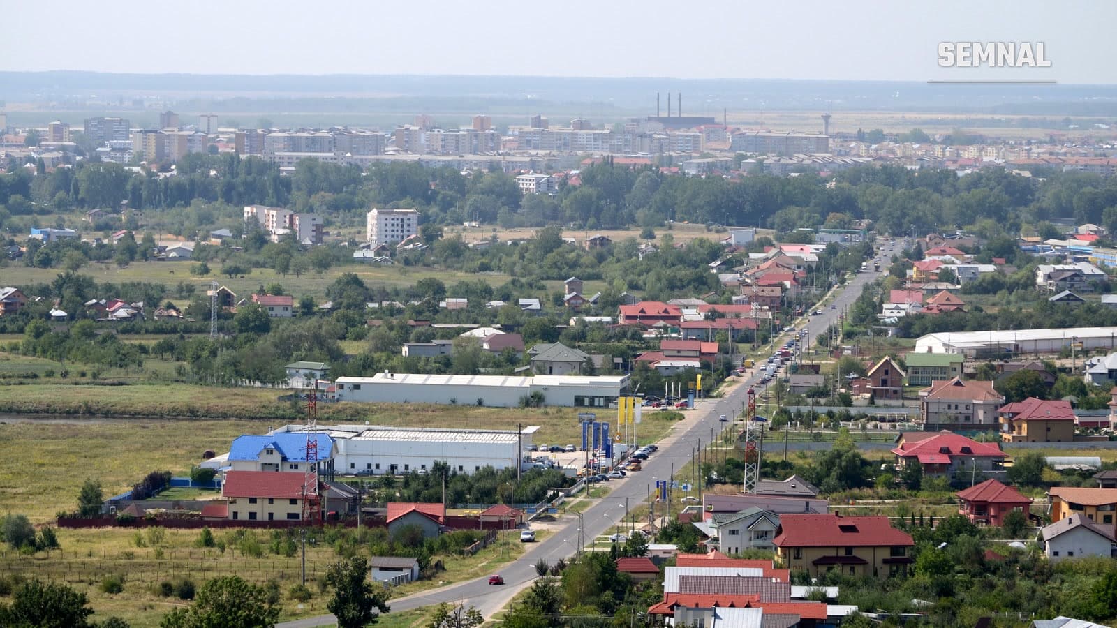 DN 72 la intrarea în Târgoviște, văzut de sus, cu case și hale de o parte și de alta a drumului