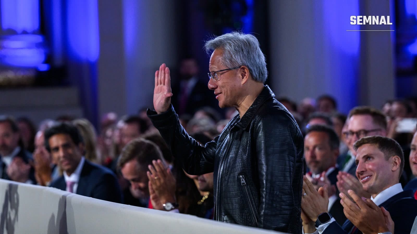Jensen Huang, directorul general al Nvidia, în geacă neagră de piele, salută publicul care aplaudă la un summit despre AI organizat de Casa Albă la Washington